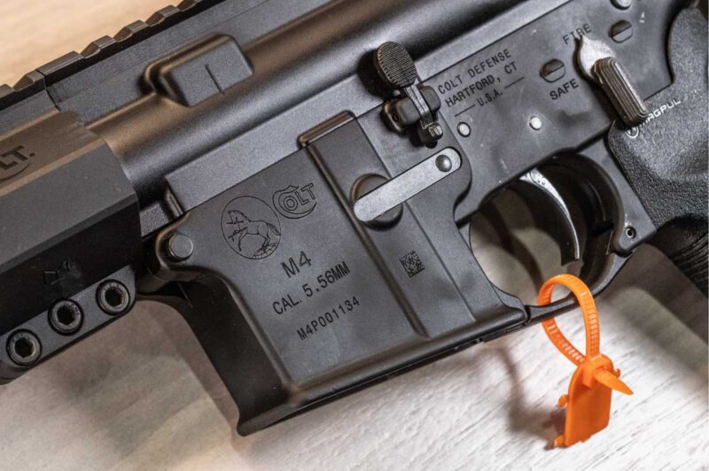 Close-up of the Colt M4 Braced Pistol lower receiver showcasing Colt Defense Hartford markings, ambidextrous controls, and classic M4 roll marks.